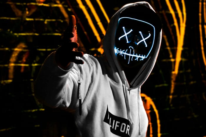 Uncover the hidden: How do I know if I am on the Dark Web? 2 how do i know if i am on the dark web represented by hacker in glowing mask